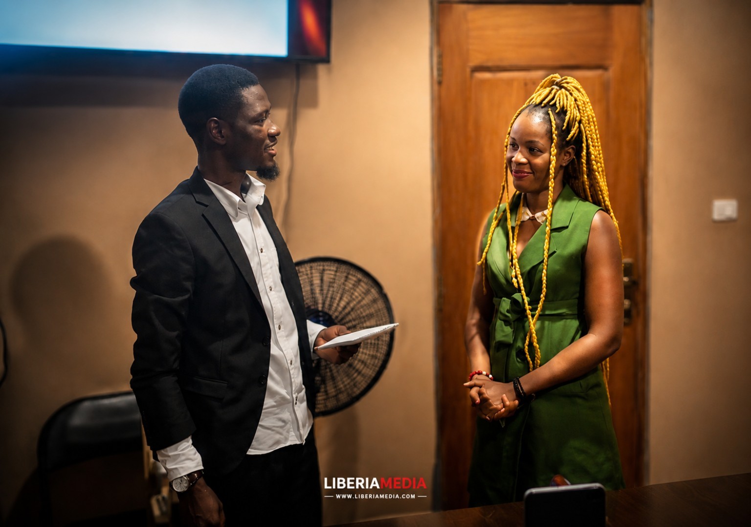 Abdul Karim Sheriff stands with second-place winner Pauline during Liberia competition prize ceremony