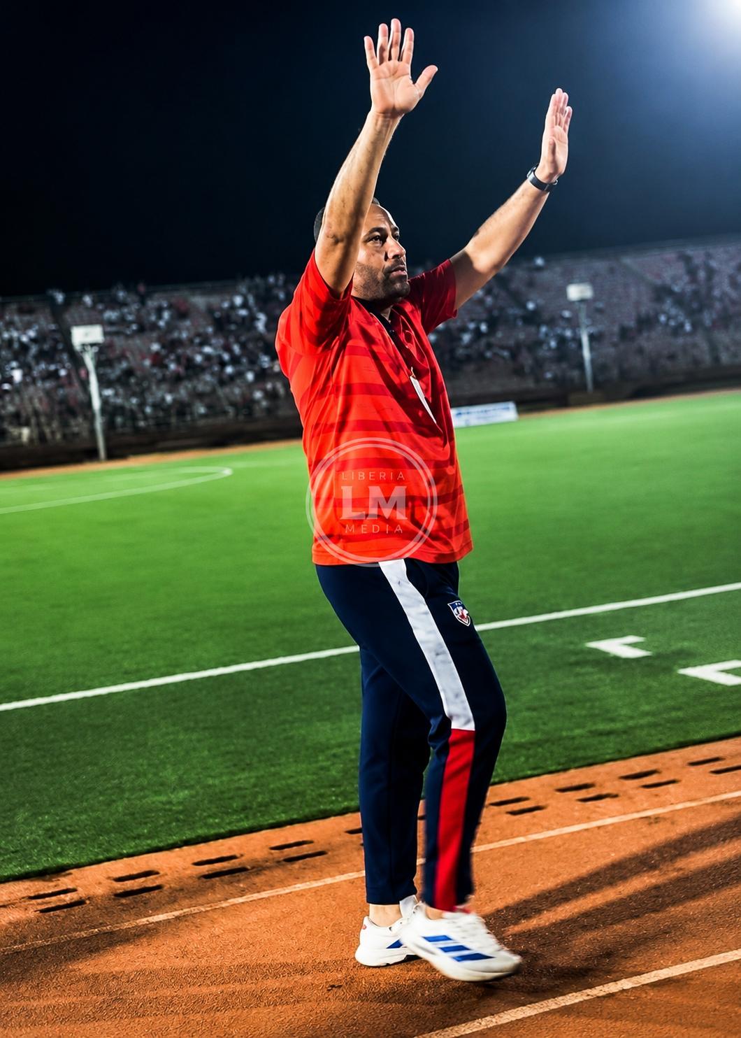 Liberia head coach Mohammed Erradi acknowledges supporters during Liberia's 3-1 victory over Sierra Leone at SKD Sports Complex.