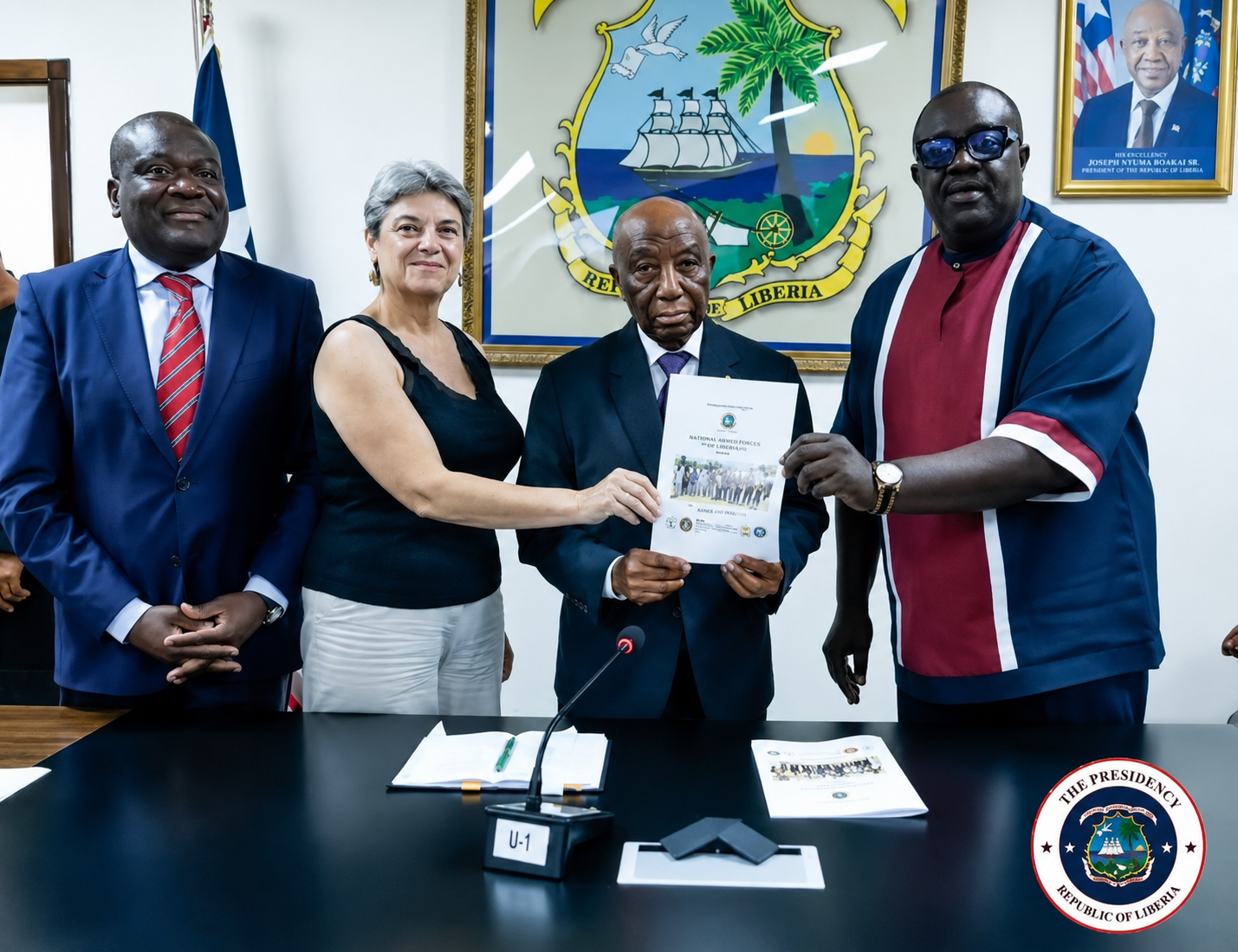 President Joseph Nyuma Boakai receives a migration assessment report from LRRRC Executive Director Cllr. Jeror Cole Bangalu and international partners during a meeting at the Executive Mansion in Monrovia.