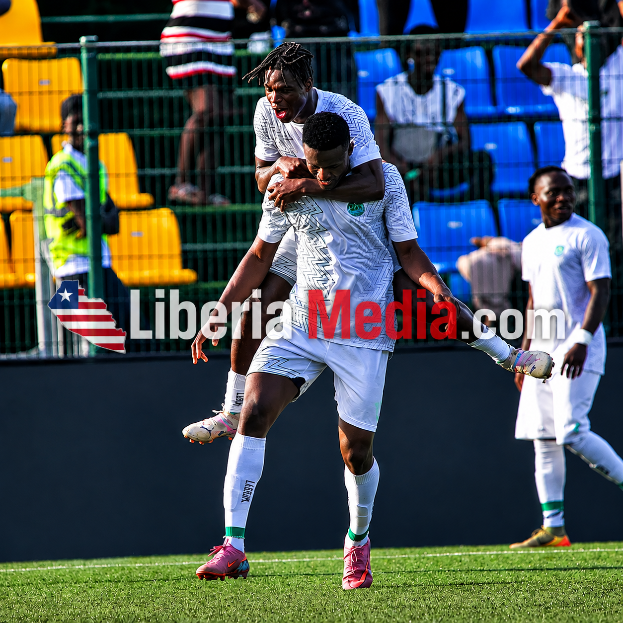Sierra Leone national football team players celebrating on the field during a football match with LiberiaMedia.com waterma
