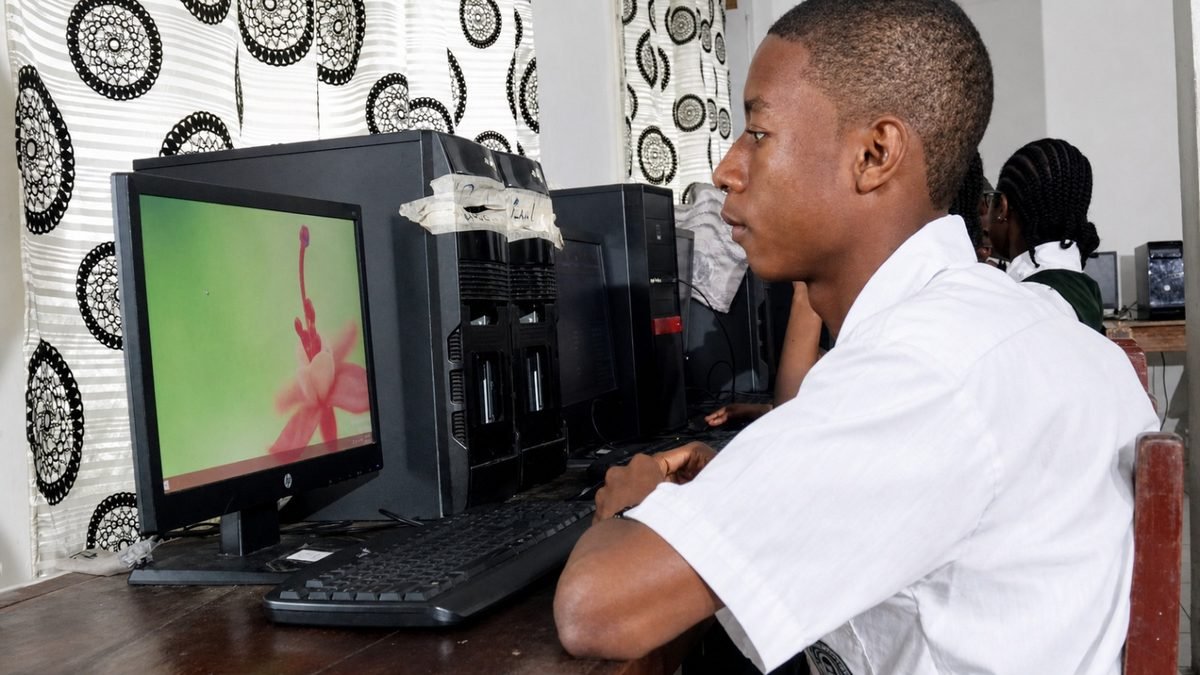 Student in Computer Lab Liberian student in school uniform working at a desktop computer in a school computer lab