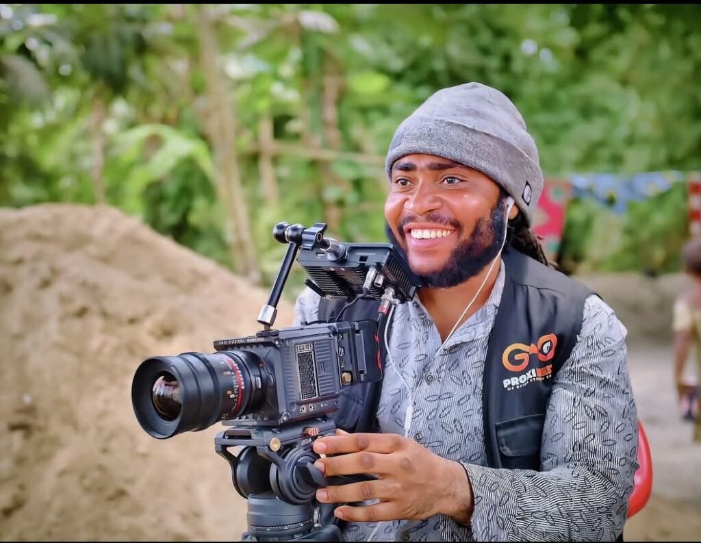 Melvin Geplay filming with a cinema camera on location for GM Online TV
